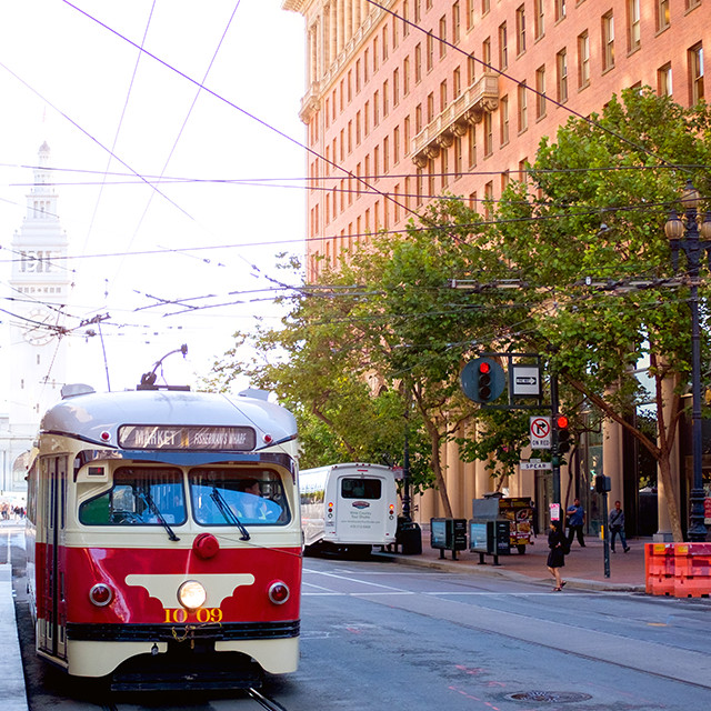 San Francisco Market Street trolley drives by the office building of Visa One Market office.